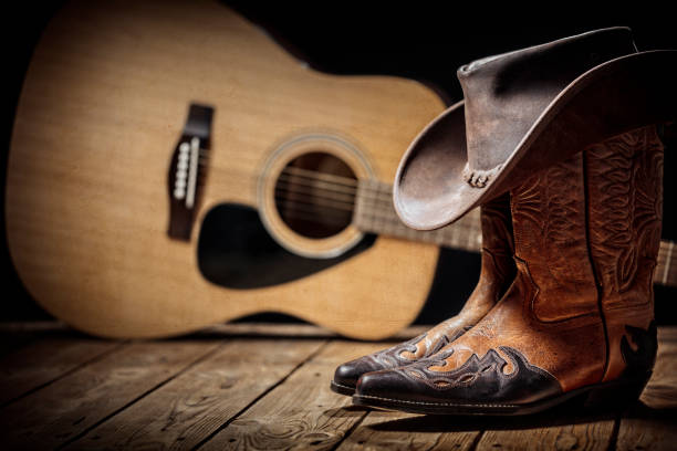 Country+music+festival+live+concert+with+acoustic+guitar%2C+cowboy+hat+and+boots+background