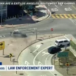 Damaged silver Toyota after a CHP chase ended in a crash near a freeway exit in Alhambra