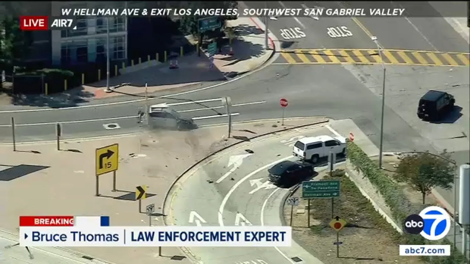 Damaged silver Toyota after a CHP chase ended in a crash near a freeway exit in Alhambra