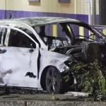 Charred vehicle near a utility pole crash scene along Jackson Keller Road in Castle Hills