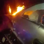 Deputy reaches into a burning SUV during a nighttime rescue after a high-speed chase